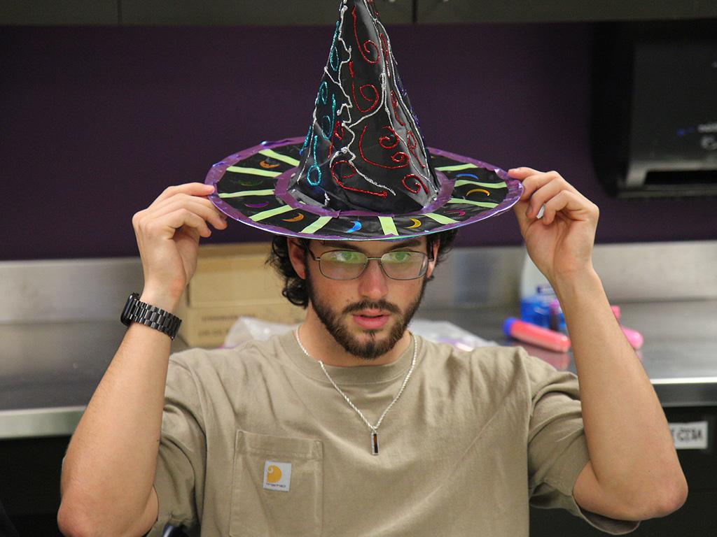 An HPU student wearing a wizard hat for the interactive session